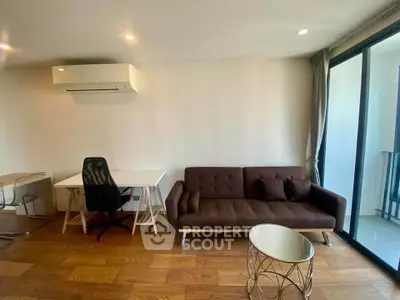 Modern living room with sleek furniture and balcony access