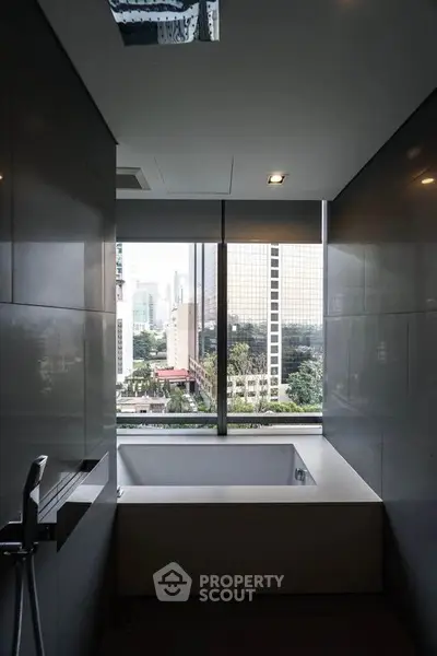 Luxurious bathroom with city view and modern bathtub