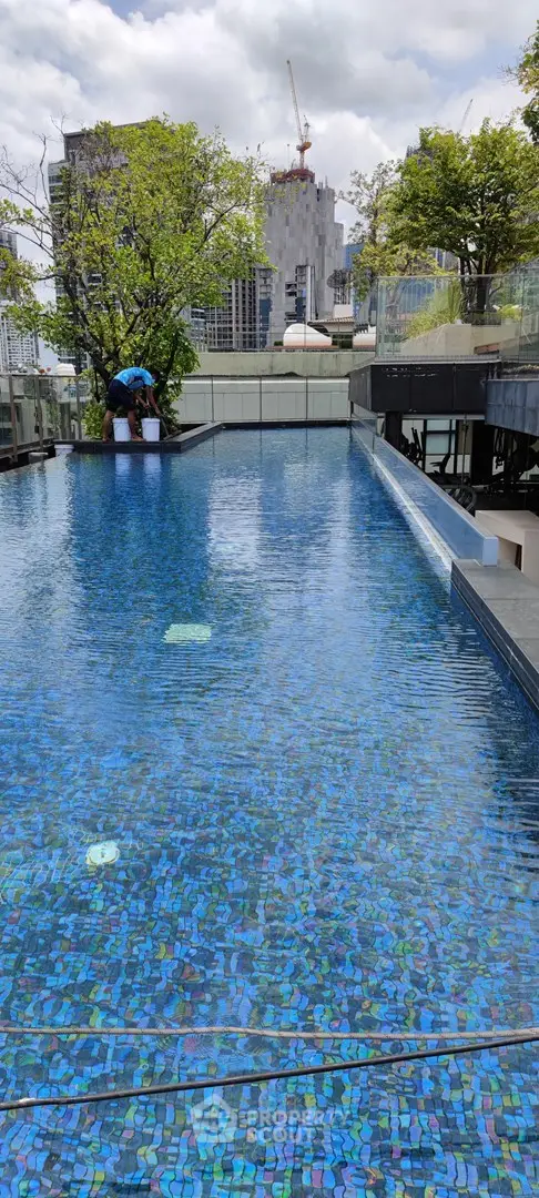 Luxurious rooftop pool with city skyline view, perfect for relaxation and leisure in urban living.