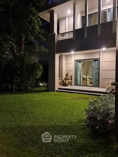 Elegant two-story home with lush garden and modern architecture