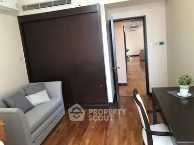 Cozy living room with wooden flooring and modern furniture in a stylish apartment.