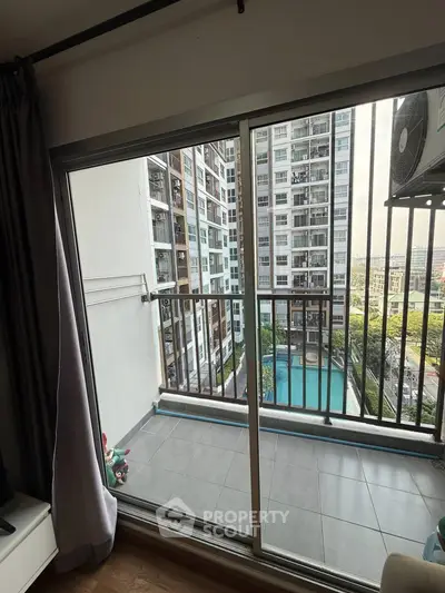 Modern apartment balcony with pool view in urban high-rise building