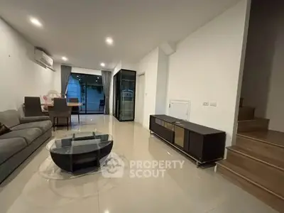 Spacious modern living room with sleek furniture and open layout, perfect for entertaining.