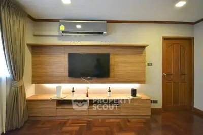 Modern living room with wooden flooring and stylish entertainment unit