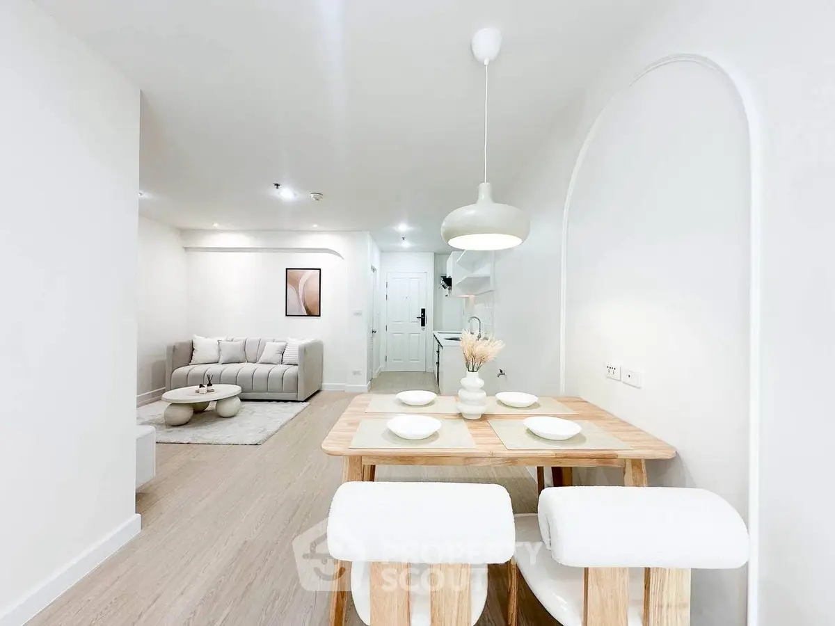 Modern open-plan living and dining area with stylish decor and neutral tones.