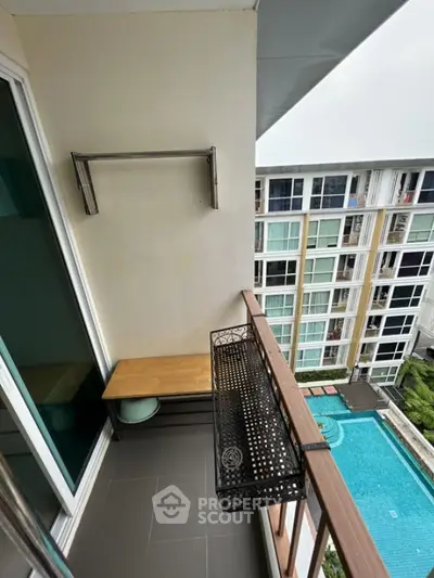 Charming balcony with pool view in modern apartment complex