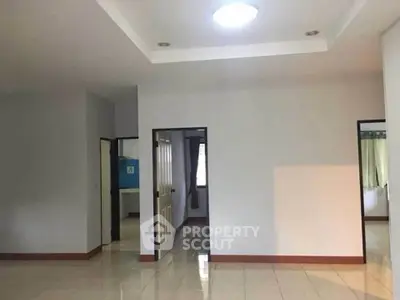 Spacious interior with tiled flooring and multiple doorways, ideal for customization.