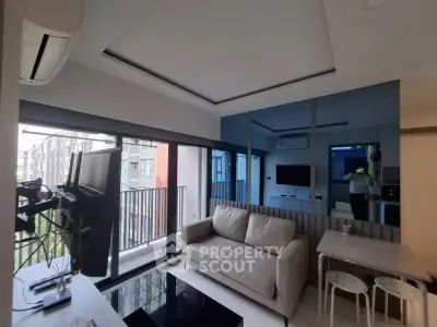 Modern living room with large windows and stylish decor in urban apartment.