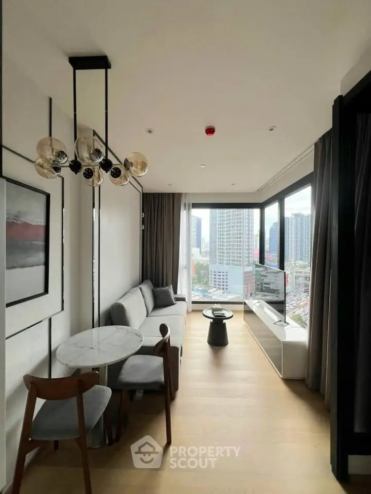 Modern living room with panoramic city view, stylish furniture, and elegant lighting in a high-rise apartment.