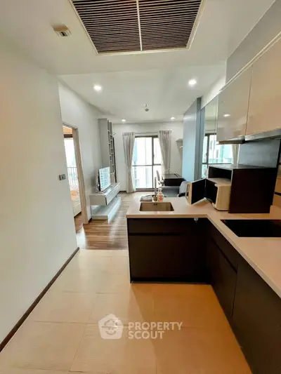 Modern open-plan kitchen and living room with sleek design and natural light.
