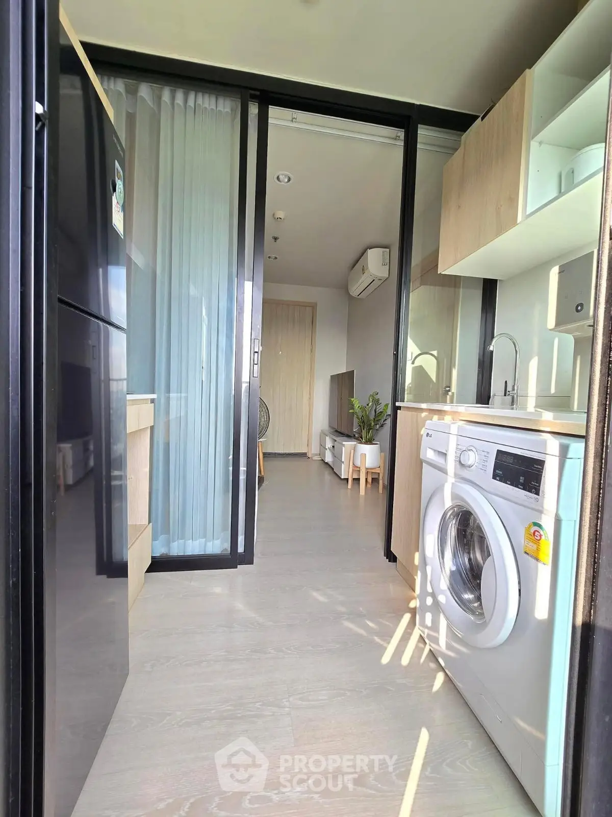 Modern apartment kitchen with washing machine and sleek appliances