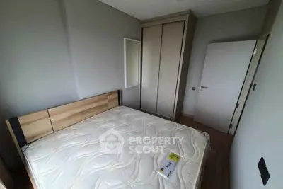 Modern bedroom with minimalist design and built-in wardrobe, perfect for urban living.