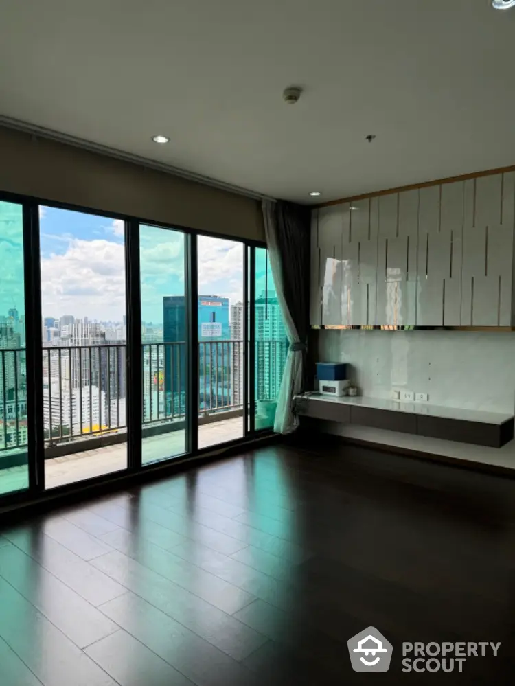 Spacious modern living room with city view and large balcony access