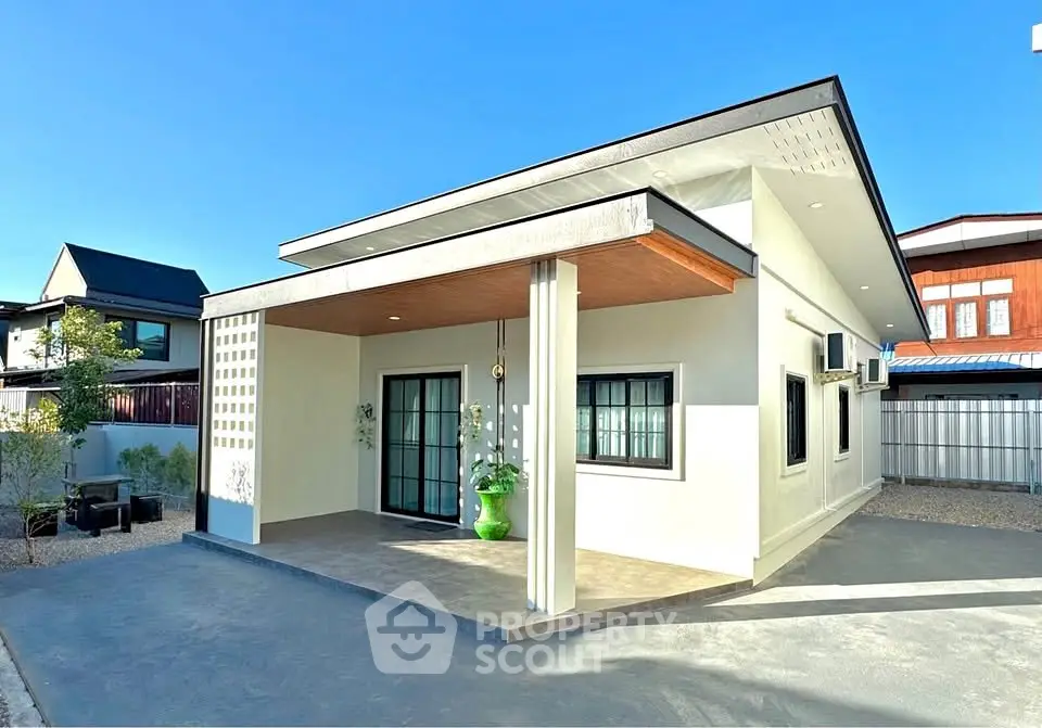Modern single-story house with spacious front porch and sleek design