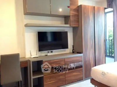 Modern bedroom with sleek wooden furniture and wall-mounted TV