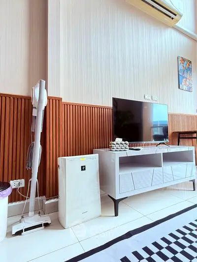 Modern living room with sleek TV stand, air purifier, and stylish decor