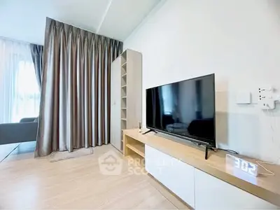 Modern living room with sleek TV setup and elegant curtains