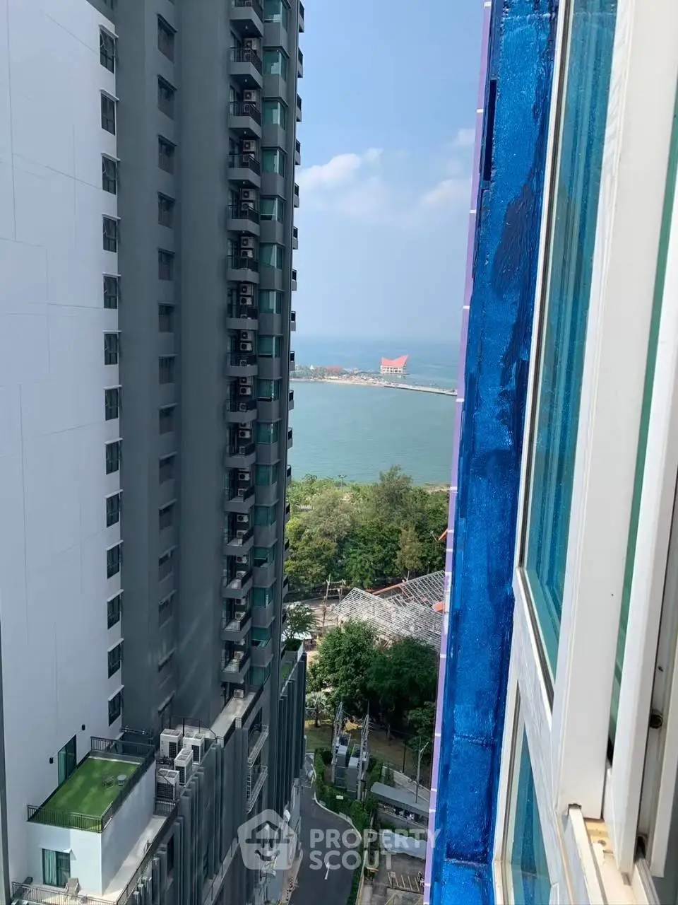 Stunning ocean view from high-rise building window, perfect for urban living.