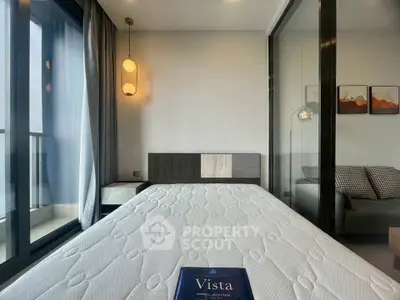 Modern bedroom with balcony access and stylish decor in a high-rise apartment.