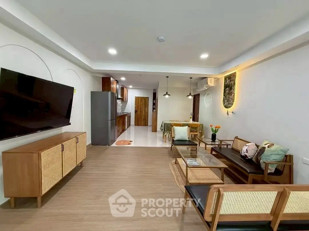 Stylish open-plan living room with modern kitchen and elegant decor