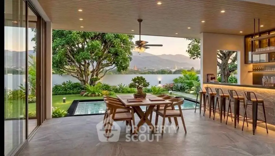 Luxurious open-air dining area with pool and scenic mountain view