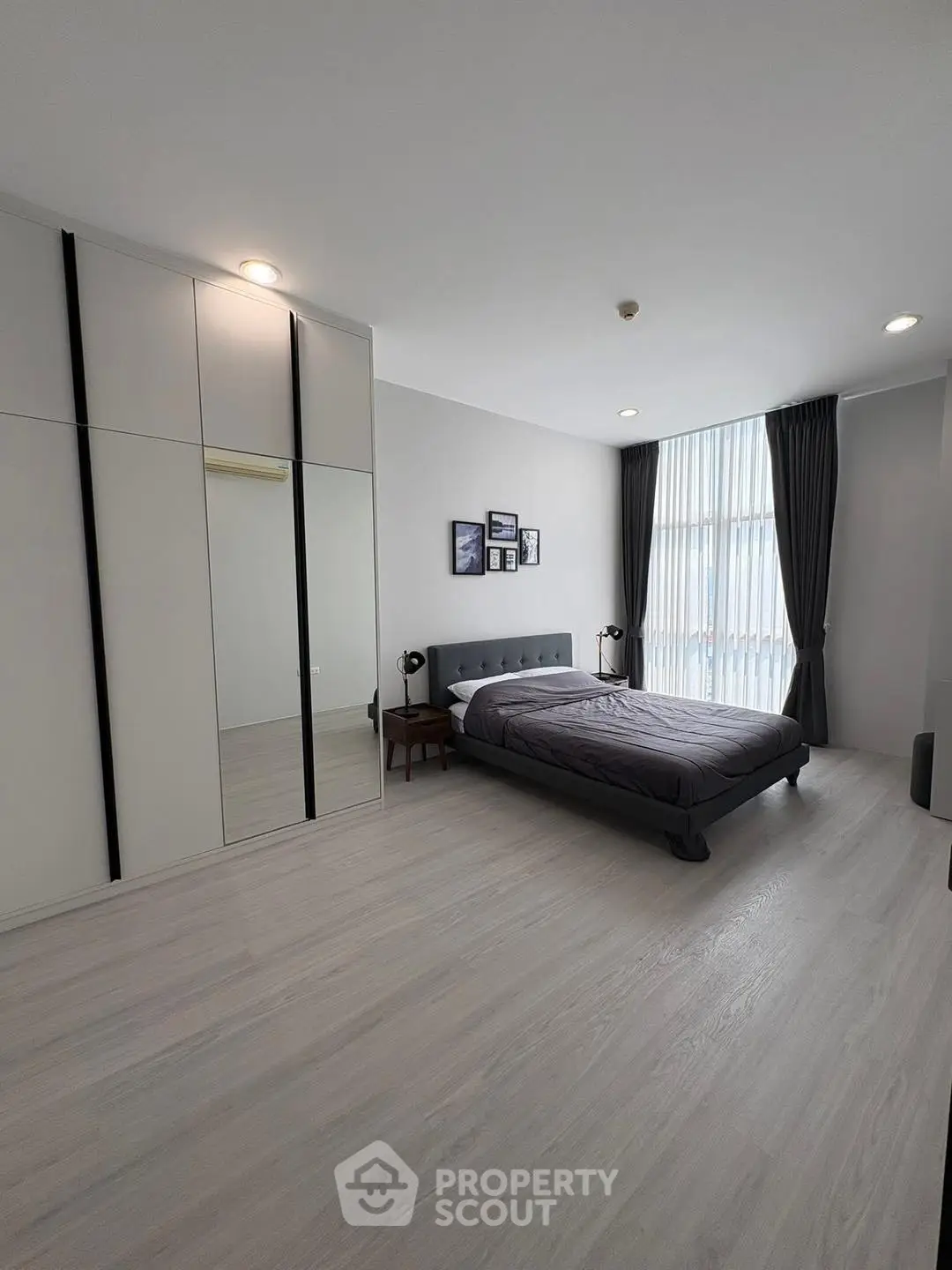 Spacious modern bedroom with sleek design and ample natural light