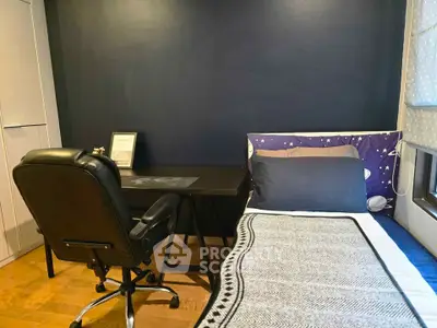 Cozy bedroom with desk and chair, perfect for study or work from home setup.