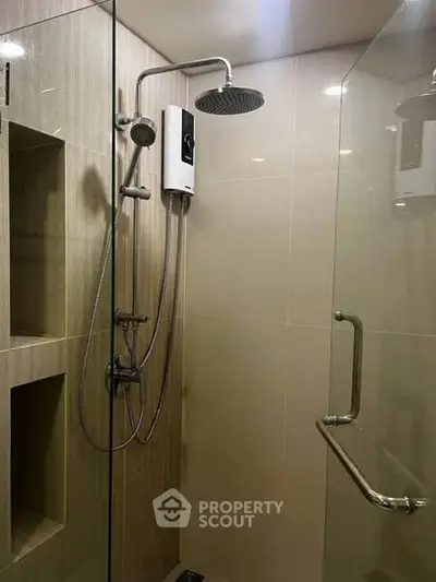 Modern bathroom with glass shower enclosure and sleek fixtures