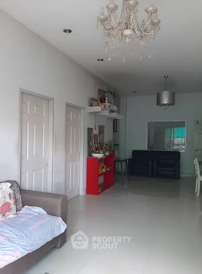 Spacious living room with elegant chandelier and modern decor