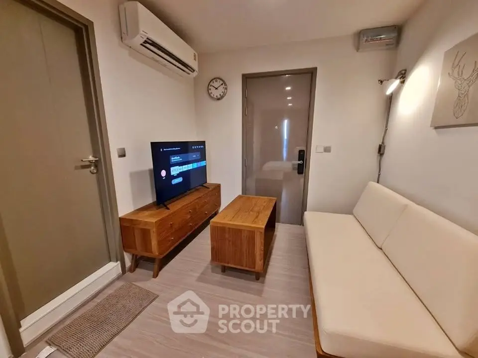 Cozy living room with modern furniture and air conditioning in a stylish apartment.