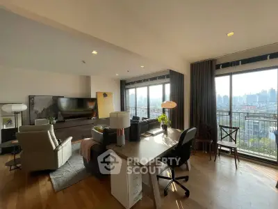 Spacious living room with city view, modern furniture, and natural light.