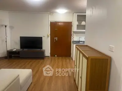 Spacious living room with modern decor and open kitchen layout