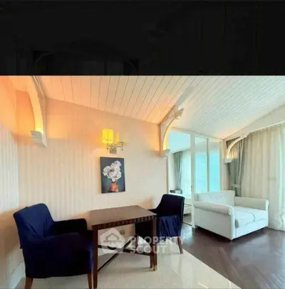 Charming living room with elegant decor and natural light, featuring cozy seating and stylish wall art.
