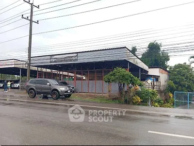 Commercial property with spacious parking area and roadside access, ideal for business opportunities.
