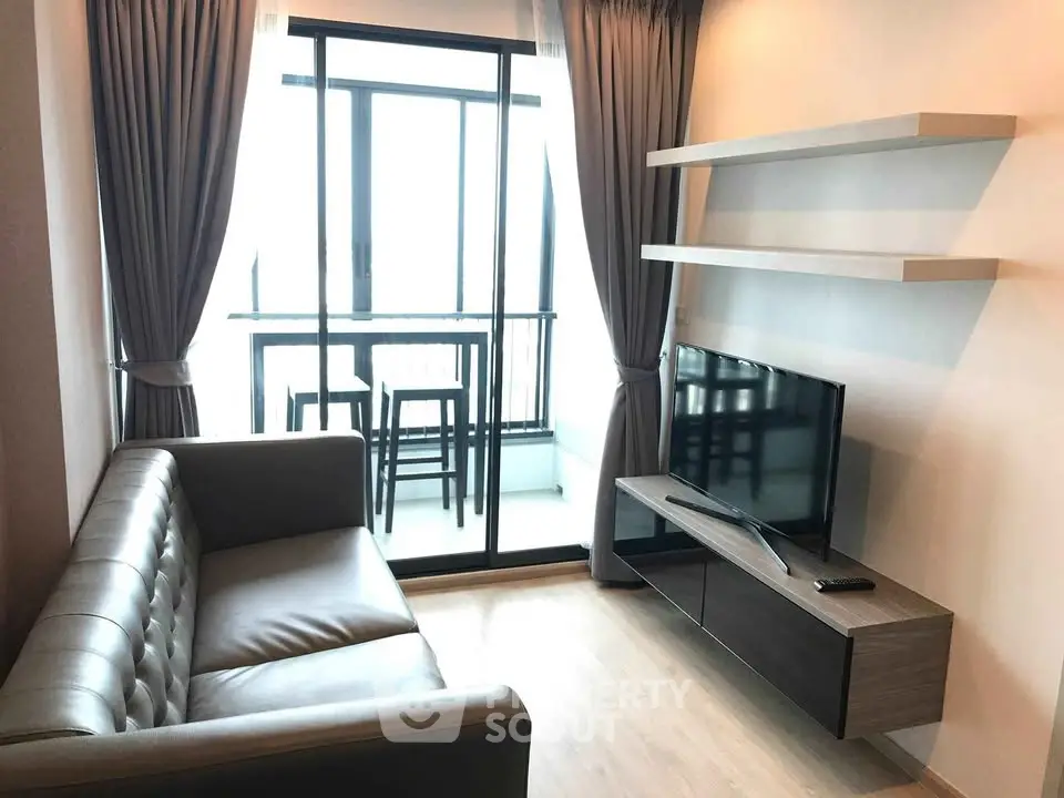 Modern living room with sleek furniture and balcony view, perfect for urban living.