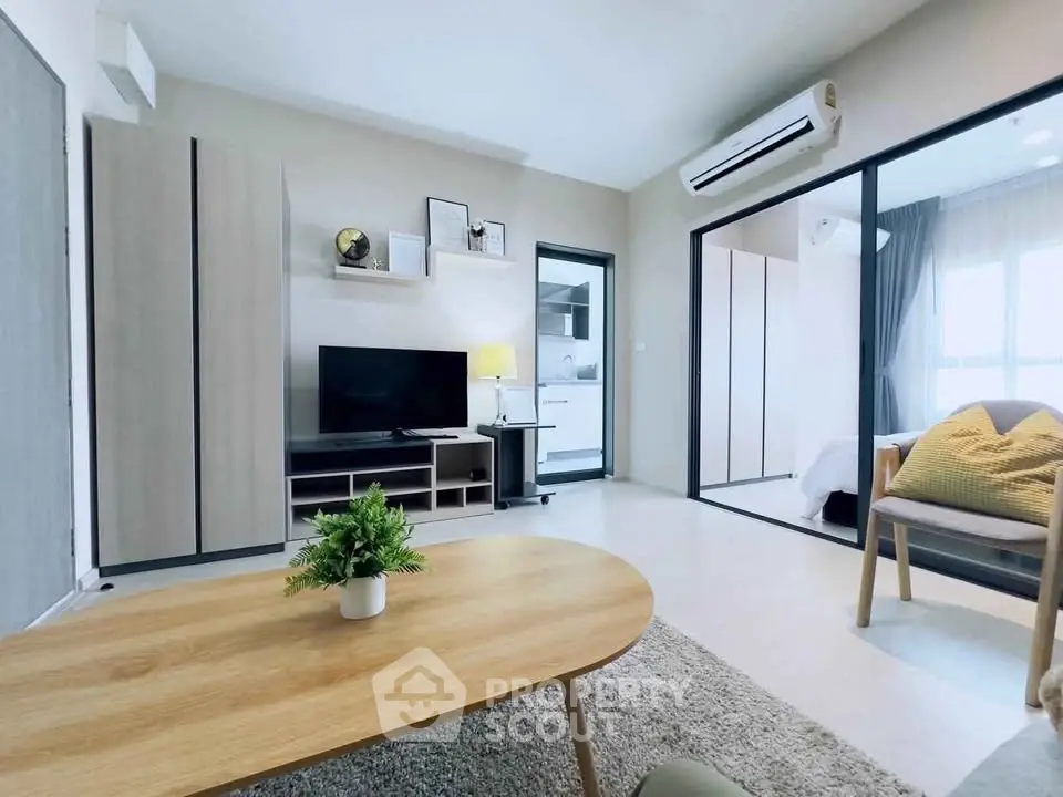 Modern living room with open layout and stylish decor, featuring a cozy seating area and natural light.