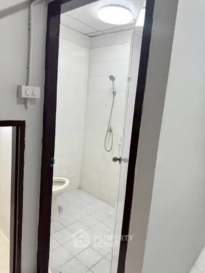 Compact bathroom with shower and toilet in minimalist design