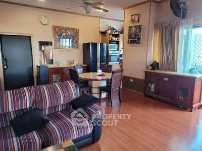 Spacious living room with stylish furniture and modern appliances, perfect for comfortable living.