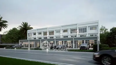 Modern townhouse complex with sleek design and ample parking space.