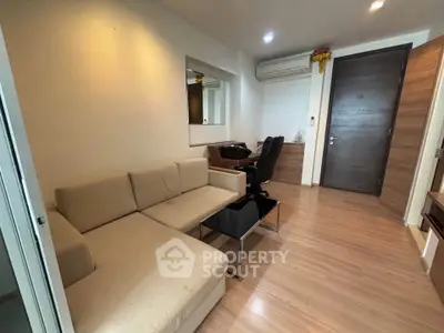 Modern living room with beige sofa and sleek wooden flooring