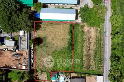 Aerial view of a spacious plot of land with road access, ideal for development.