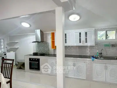 Spacious kitchen with modern appliances and open layout, perfect for culinary enthusiasts.