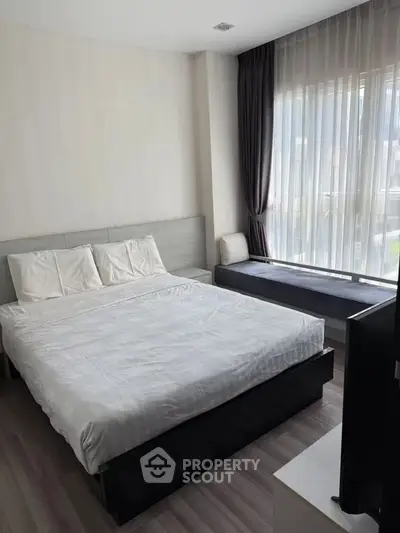 Modern bedroom with large window and stylish decor