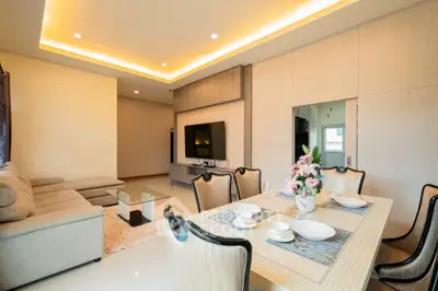 Elegant living room with modern dining area and cozy seating, ideal for family gatherings.