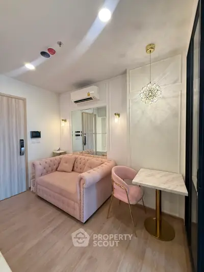 Chic modern living room with plush pink sofa and elegant lighting