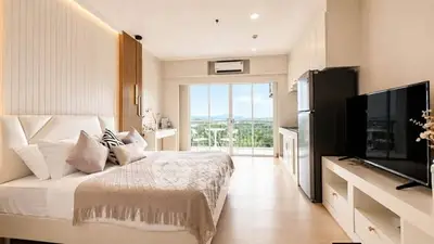 Luxurious modern bedroom with stunning view and sleek furnishings in high-rise apartment.