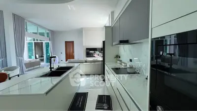 Luxurious modern kitchen with sleek design and open layout, featuring high-end appliances and spacious living area.