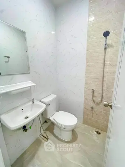 Modern bathroom with sleek white fixtures and elegant tile design