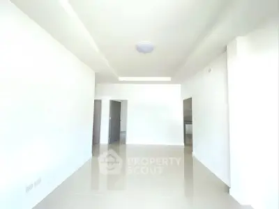 Spacious modern living room with sleek tile flooring and minimalist design.