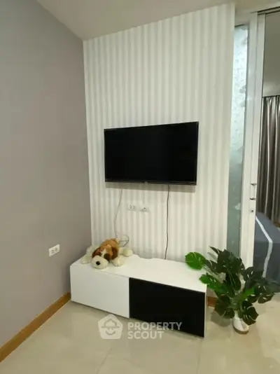 Modern living room corner with wall-mounted TV and stylish decor